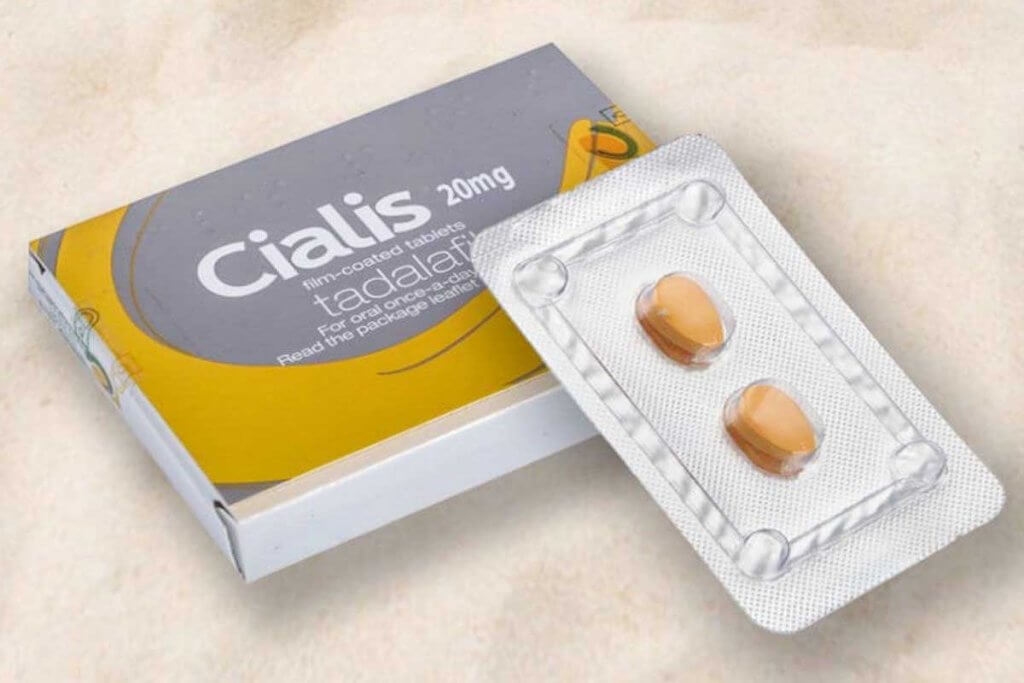 Tadalafil pills beside a heart symbol showing improved blood flow